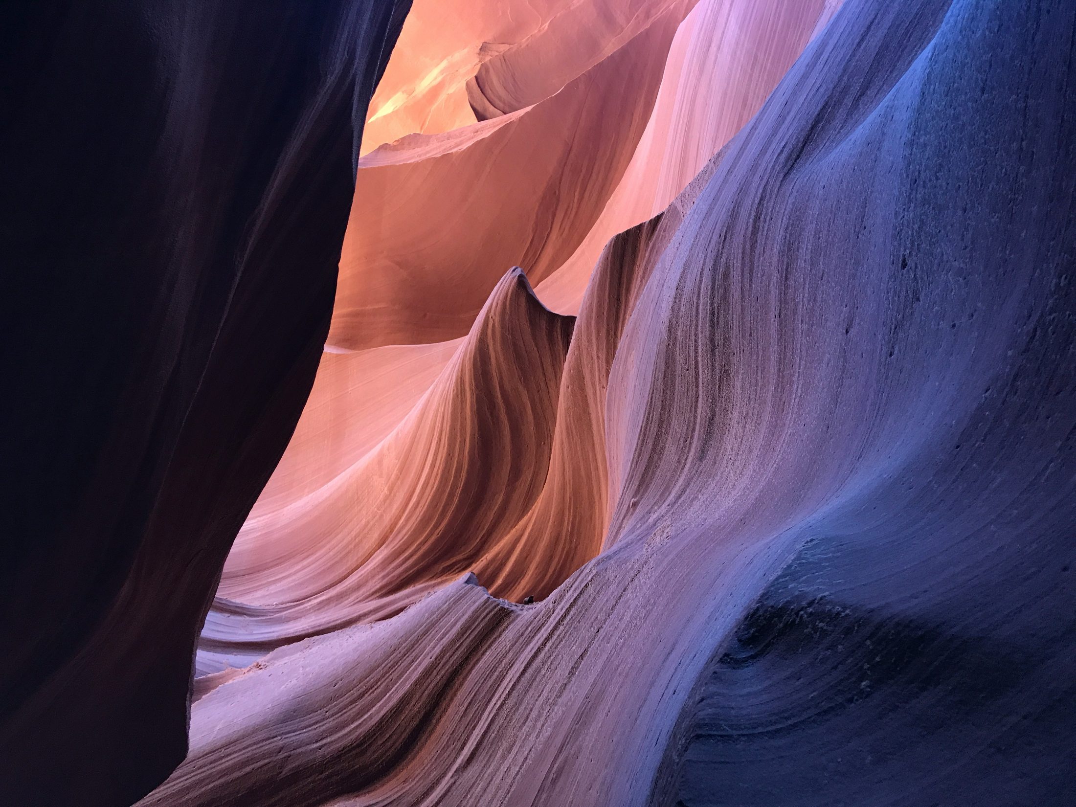 Light falling across the curved walls of a sandstone canyon